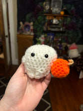 Load image into Gallery viewer, Little Crochet Ghost holding a pumpkin
